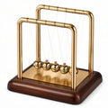 Pendolo di Newton decorativo in oro con base in legno